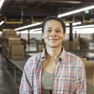 Portrait of an African American female warehouse worker in a large distribution warehouse with